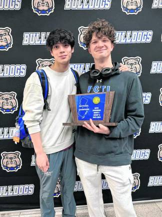Passaic County Technical Institute students Zachary McKatten and Tyler Roer hold the NJSIAA North 1, Group A trophy after defeating rival Ridgewood in the finals.