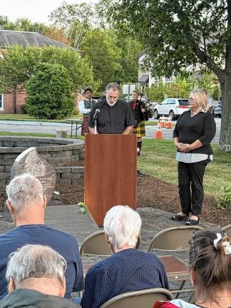 The Rev. Christopher Doyle gives the opening prayer. At right is Mayor Michele Dale.