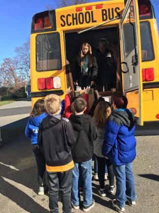 PHOTO PROVIDED Students from Upper Greenwood Lake School "Stuff the Bus" with donated food for the West Milford Presbyterian Church's pantry and the Women's Shelter.