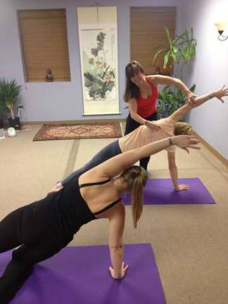 Kim Minervini, MSPT, certified Pilates instructor, helps with form at West Milford Physical Therapy.