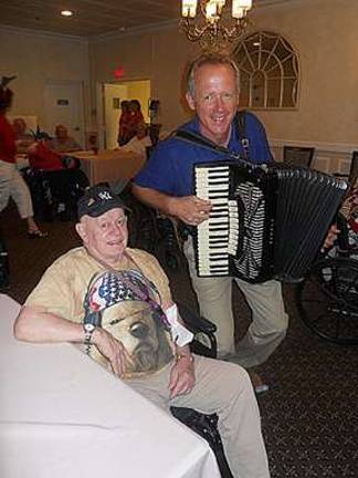 Harry Siley, left, enjoys the music of Eric Kerssen.