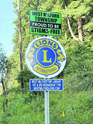 A sign showing West Milford is “stigma free” is shown alongside a road.