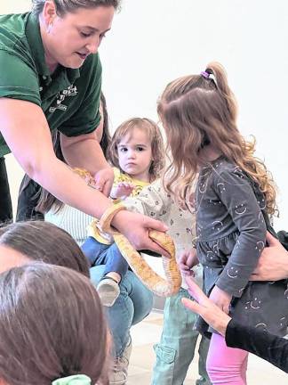 Devon Santoro shows the children a snake.