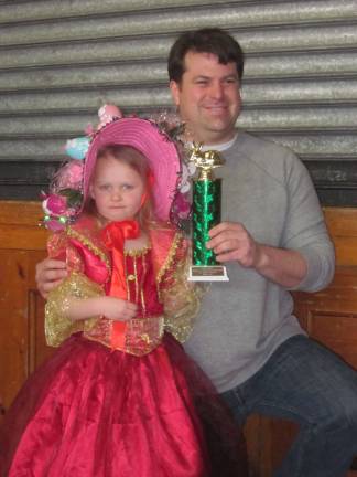 Willow took first place in the annual bonnet contest at Hillcrest Community Center. Here she is wearing her beautiful bonnet with her proud uncle, Councilman Mike Hensley.