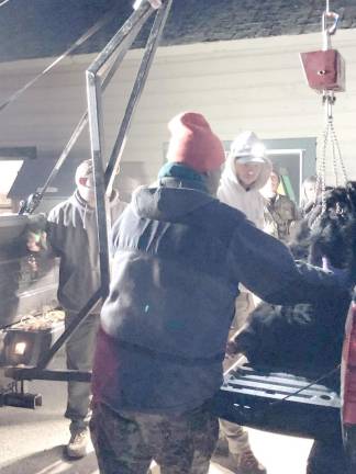 New Jersey Fish and Wildlife officials weigh a bear brought to the check-in station late Saturday afternoon, Dec. 10 at the Whittingham Wildlife Management Area in Sussex County.
