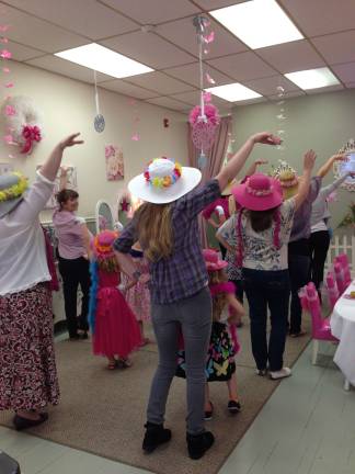 They do more than drink tea at Her Royal Highness. They also learn the proper way to wear a hat.