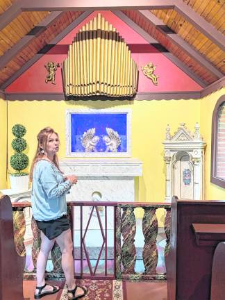 Christine Vander Ploeg stands in a room based on fairy tale.