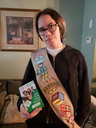 Amber Vitoulis with badge sash and cookie stash. (Photo provided)