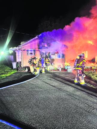 Firefighters on the scene at a house fire on Elm Street.