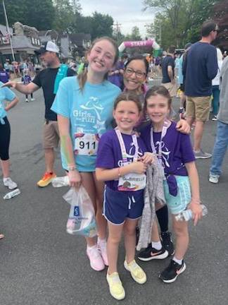 Gabby Steffens and Abby Coleman, both fourth-graders, pose with Gabby’s running buddy, Clara Steffens of Stillwater, and Jill Steffens, mother and coach of the GOTR chapter at Sussex County Charter School for Technology in Sparta.