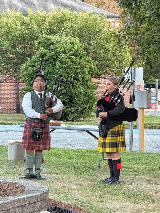 Joseph Smolinski and Pipe Sergeant Peyton Lowenstein play the bagpipes.
