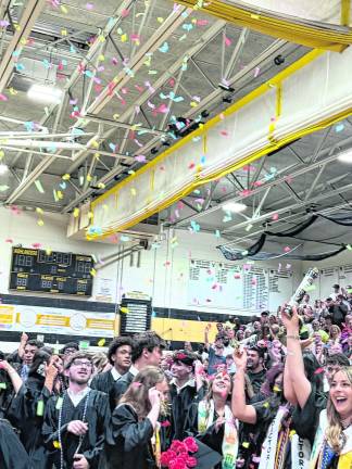 Confetti falls from the gym ceiling.