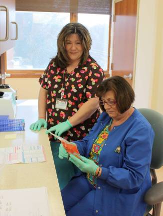 Phlebotomists Jennifer Wilhelm, on left, and Diana Pruzinsky, staff the Chilton Lab Patient Service Center in the Hewitt Plaza building in West Milford. The lab, a satelite of Chillton Hospital, offers convenient, walk-in service for most tests. Photo by Ginny Raue