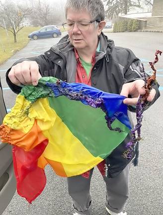 Sue Harris holds a Pride flag that was found burned on the ground of the Sparta United Methodist Church in January 2022. That incident spurred the founding of PFLAG Sussex County. (Photo provided)