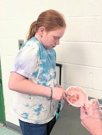Brooke Prosper, 9, of West Milford mixes prior to baking.