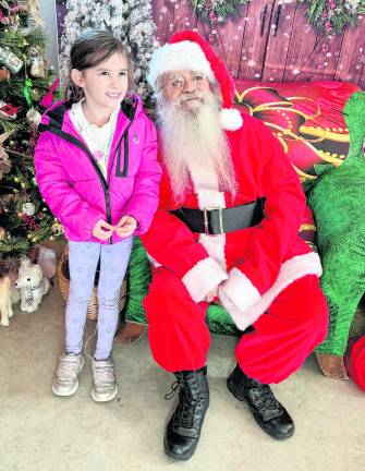 Ellison Faulch, 7 of West Milford poses with Santa Claus.