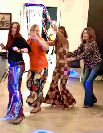DA1 Fran Lanza, wearing harlequin bell bottoms, takes part in a dance line during the ’70s Dance Night on Saturday, Aug. 23 at the Wallisch Homestead. (Photo by Fred Ashplant)