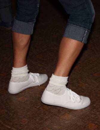 Rolled up jeans, rolled down socks and sneakers are a definite 50s look.