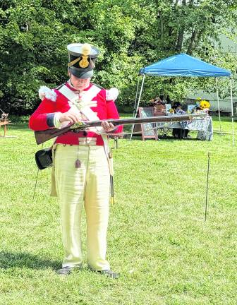 John Van Vliet, president of the Royal Essex Society, demonstrates preparing a Victorian era rifle to shoot.
