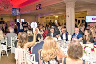 Attendees of the Annual Passaic County CASA Gala take part in a table auction on Sept. 20.