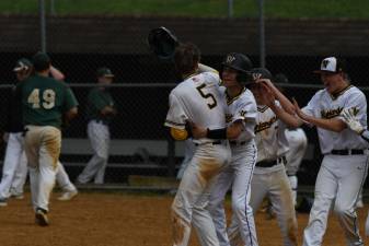 Team celebrates Kai Foster’s (5) walkoff hit to defeat Passaic Valley in 2021