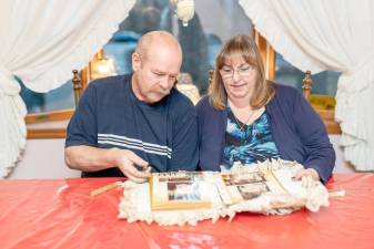 Michael and Karen Joy of West Milford look through their wedding photos.