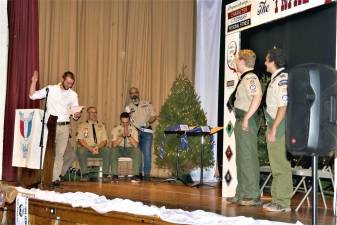 Scouts Nick Salleroli and Sean Rodriguez take the oath as new Eagle Scouts during a ceremony on Saturday.