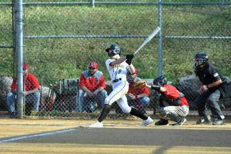 Senior catcher Charlie King hits the ball.