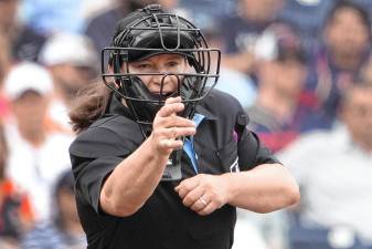Home plate umpire Jen Pawol calls a strike during the third inning of a spring training baseball game between the Miami Marlins and Houston Astros on March 10, 2024, in West Palm Beach, Fla. (AP File Photo/Jeff Roberson)