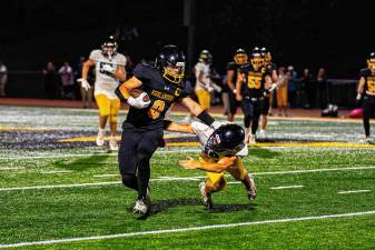 West Milford High School senior Chase Tyburczy uses a stiff-arm to evade the tackle in the game against Jefferson on Friday, Sept. 5. The Highlanders won, 34-6. (Photos by TJ Nolan)