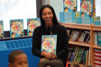Author Alicia McKenzie reads her book to a group of children. Photo provided.