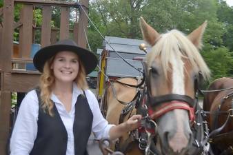 Young woman drives the stagecoach