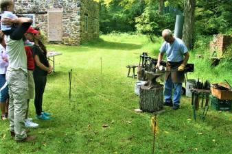 Wycoff Blacksmith Gaspar Lesznik conducts a field demonstration of 19th century metal work at the Long Pond Ironworks State Park in Ringwood last week. (Charles Kim photo)