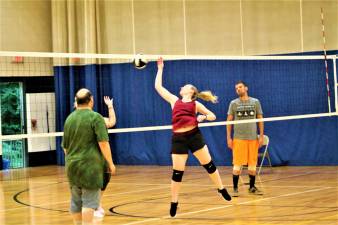 Guest instructor Meghan gives participants some tips during Wednesday night's co-ed volleyball class.