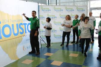 Mike Strusiak signs the flag for the Transplant Games this summer.