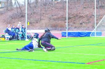 A Sparta player is tagged out at home plate. Newton High School took on Sparta High School in a girls varsity softball scrimmage. The contest was played on Saturday, March 29, 2014 at Newton High School in Newton, New Jersey.