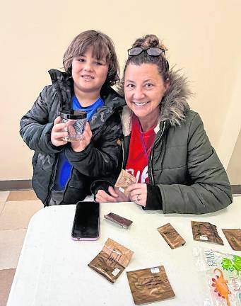 Kai Erich, 6, and his mother, Kay Erich, both of West Milford, share their seeds.
