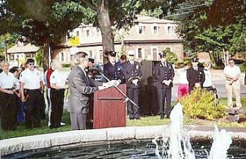 West Milford has a special park honoring the victims of 9/11. It is on the front lawn of the municipal building and was suggested and constructed by a businessman who wants to remain anonymous. The photo shows the late Mayor Joseph DiDonato conducting a memorial service soon after the memorial was established.