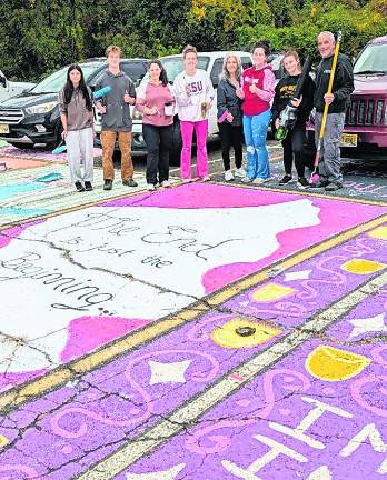 About 40 West Milford High School seniors with help of several parents do the annual ritual of painting assigned parking spaces with bright colors, fun designs and personal messages on Sunday, Oct. 4.