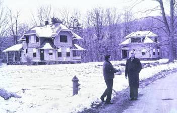 Richard DuHaime, Passaic County Freeholder (1985-1996) right, and late AIM Community News Publisher Joe Deery, stand on New City Road in 1995, enthusiastically discussing revitalization plans for the deserted New City community.