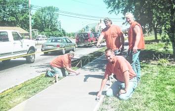 Men building a sidewalk along Union Valley Road in front of Veterans Park many years ago are Bob Vreeland, Roger Cox, Tim Vreeland and Anthony Adragna.