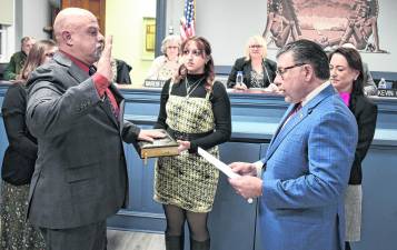 Rudy Hass, left, with his daughter holding the Bible, is sworn in to the West Milford Township Council at its public meeting on Wednesday, Jan. 7, by Senator Anthony Bucco (LD-25), who was joined by Assemblywoman Aura Dunn (LD-25).