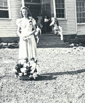 Constance (“Connie”) Struble is seen in her eighth-grade graduation dress outside Echo Lake School where she received her elementary school education through eighth grade. During a winter in the 1940s she was sleigh-riding on Germantown Road and died when her sled collided with a delivery truck. (Photo by Ann Genader)
