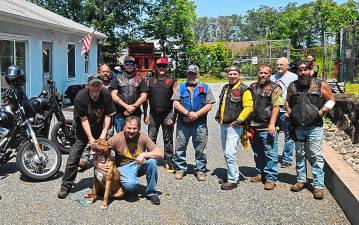 MC1 Members of the Warlocks Motorcycle Club of Sussex County donate $2,000 to the West Milford Animal Shelter Society (WMASS) on Aug. 3. The funds were raised during a recent charity event. It’s the club’s second significant donation in as many years. WMASS president Doug Weed, front, accepts the donation with Sven, a pup available for adoption. (Photo provided)
