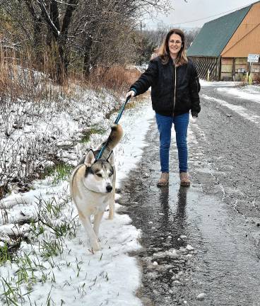 SN3 Sherry Parrilli Costa, a volunteer at the West Milford Animal Shelter, walks Lenny in the snow.