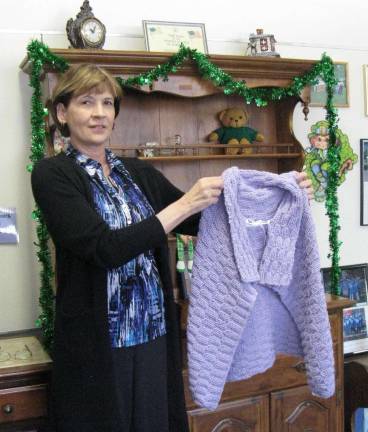 Gail Kahler, Supervisor of Senior Citizen Activities, displays one of the shawls made by the ladies