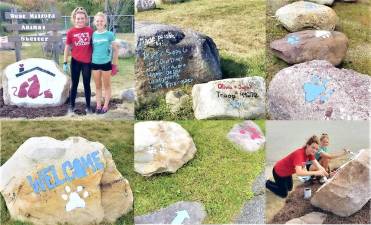 Girl Scouts Sarah Pilaar and Olivia Kinahan work on painting the rocks in front of the West Milford Animal Shelter.