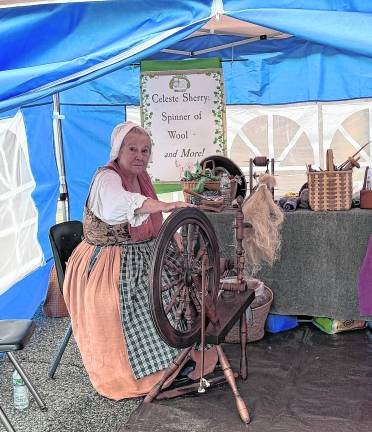 Celeste Sherry demonstrates wool spinning.
