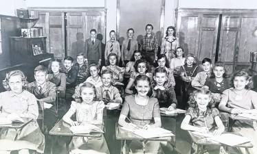 Students in the Newfoundland School upper grades are seen in 1947. The oldest were just six years old when World War II began. Students are: Row 1: Marge Sisco, Clarence Crane, Eugene Sisco. Row 2: Dawn Jennings, Wayne Post, Billy McCAnn, Sally Hewitt, Doris Post, Lawrence Davenport, Linda Chardavoyne. Row 5: LeRoy Tice, Jane Myers, Carl Stickles, Shirley Jennings, Bobby VanLuvender, Walter Crane. Row 4: Jean Richards, Carl Cahill, Jean Cahill, Ada VanderStad, George Crane, Eddie Paulison. Standing left to right: Eileen Cole, Doris Boulden, Luella Crowley Kemble teacher, Eddie VanderStad, Jerry Crane.
