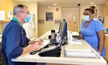 Dr. Eric Louër help Djion Holness, a third-year veterinary student at Cornell University, sharpened her skills in between semesters working at Greenwood Lake Animal Hospital this summer. Provided photo.